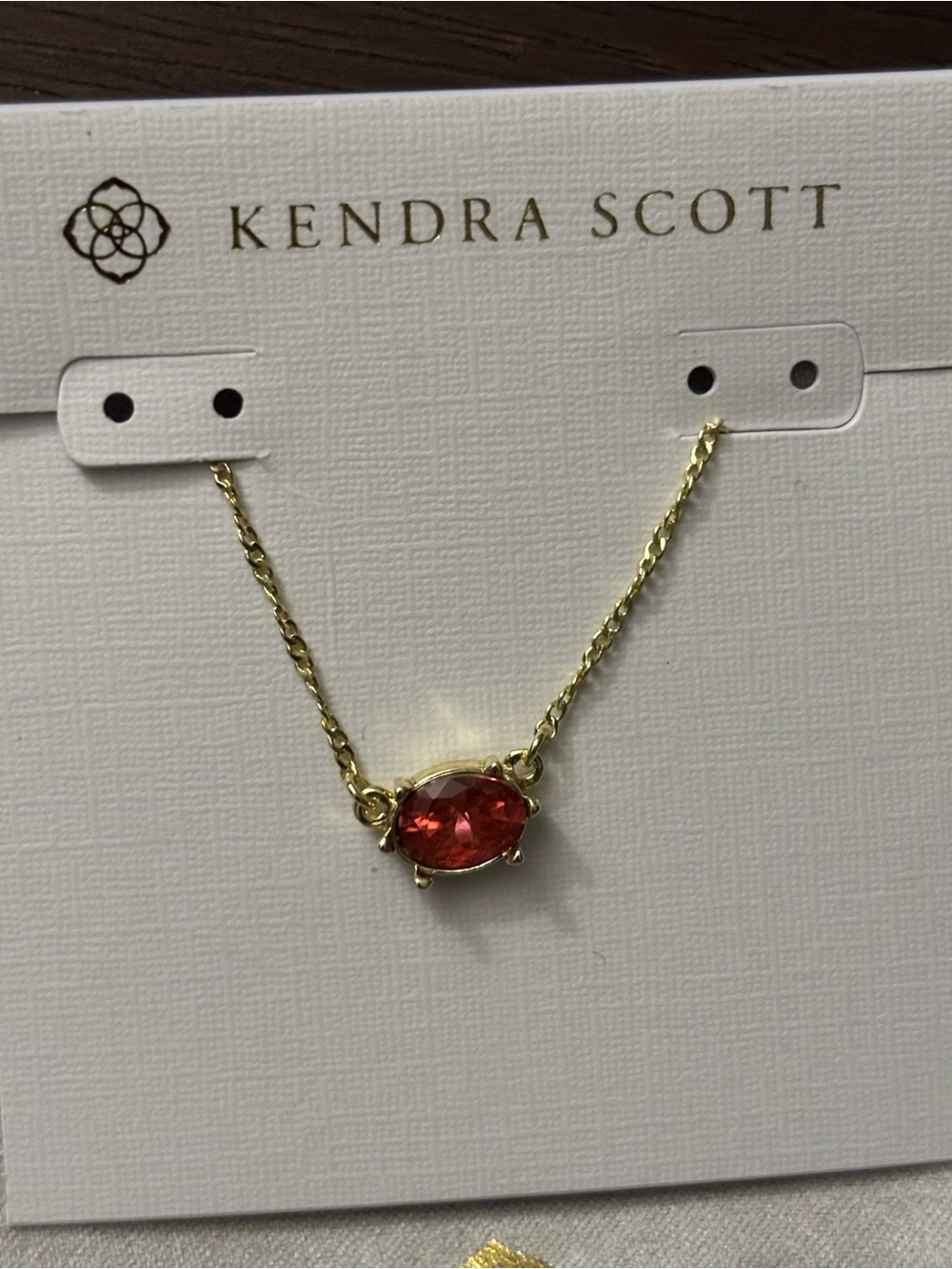 Brand new Kendra Scott Gold Necklace with pink/redish Oval Stone